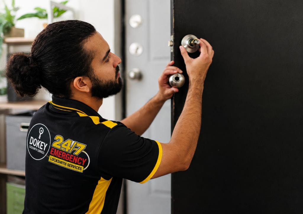 Dokey locksmith technician working on a residential door lock.